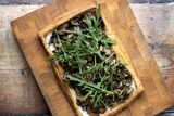 thumbnail: "I like to bake the puff pastry tart in an upturned baking tray so that when it’s baked, it’s really easy to slide off on to a serving board or plate!" Photo: Tony Gavin