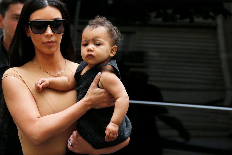 TV personality Kim Kardashian holds her daughter North in her arms as she shops in Paris May 20, 2014.  REUTERS/Gonzalo Fuentes