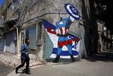 thumbnail: Graffiti in Tel Aviv depicts US president Joe Biden as a superhero. Photo: Reuters