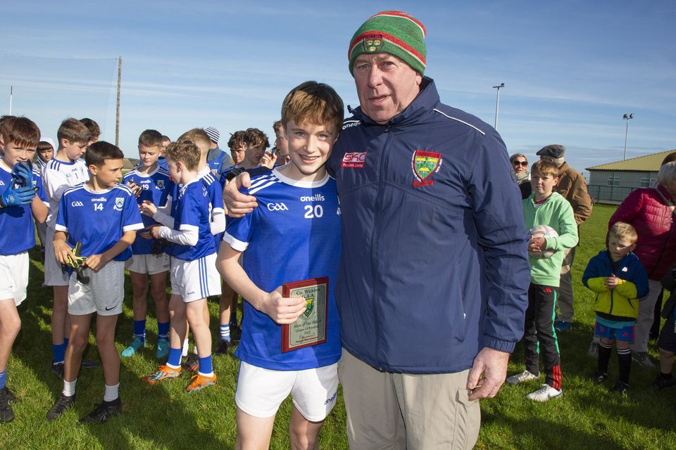 Harry Murphy presents Cillian Walsh of Éire Óg Greystones with the man of the match award after his side defeated Ashford in the Under-13 'A' football championship final in Rathnew.  