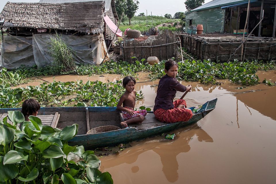 A family rides their boat to go to their home