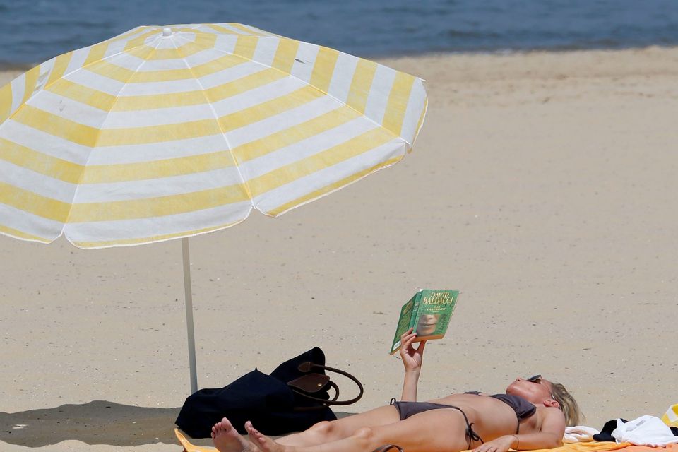 A woman sunbathes on a beach along the Bassin d’Arcachon Sea in Arcachon, near Bordeaux. Photo: Reuters/Regis Duvignau