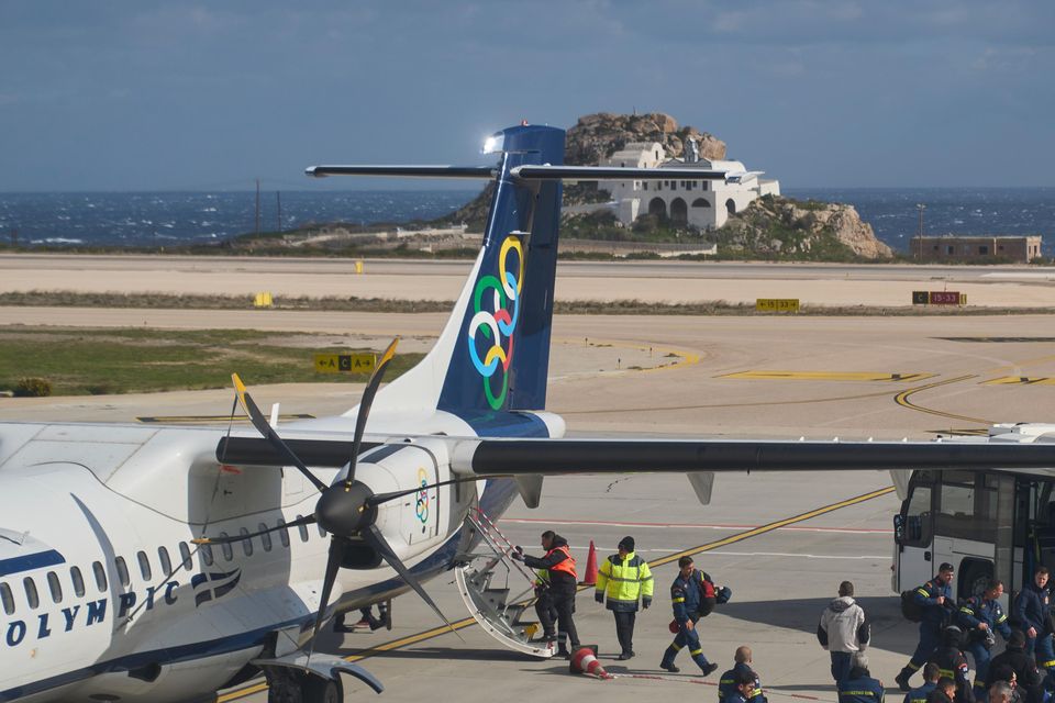 Fire service rescuers arrived at the airport of Santorini as emergency efforts were stepped up (Petros Giannakouris/AP)