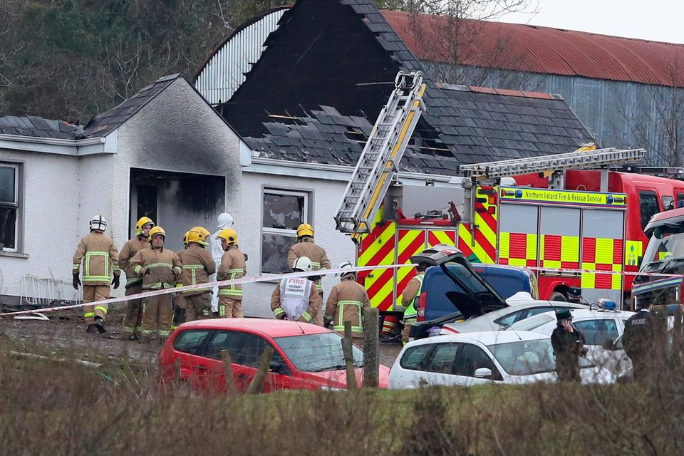 Forensic and fire officers at the house in Derrylin, Fermanagh. Photo: Brian Lawless/PA Wire
