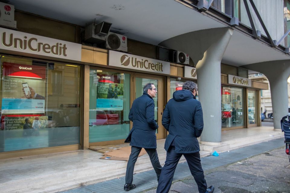 Pedestrians pass a UniCredit SpA bank branch in Rome. Photo: Alessia Pierdomenico/Bloomberg