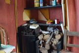 thumbnail: Provisions: Paddy's kitchen condiments shelf  is still filled, his turf and timber still stacked beside the fire; his hard fireside chair and the same calendar from 2006, the year his photo was taken for Vanishing Ireland