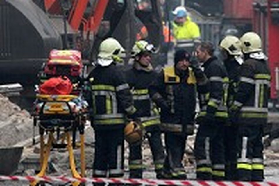 Firemen clear debris around a collapsed building in Liege, in Belgium (AP)