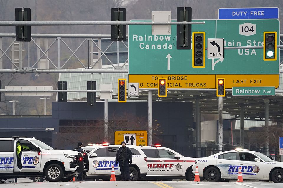 Law enforcement personnel block off the entrance to the Rainbow Bridge (Derek Gee/AP)