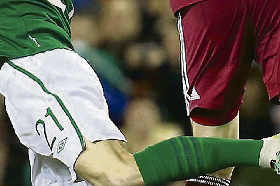 Ireland's Kevin Doyle (L) is challenged by Latvia's Aleksandrs Fertovs. Picture: REUTERS/Cathal McNaughton
