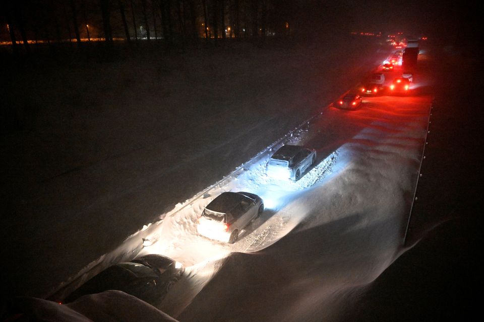 Vehicles wait in line on a snow-covered road after a snowfall in Ekerod, near Hoby, Sweden, on January 3, 2024.Johan Nilsson