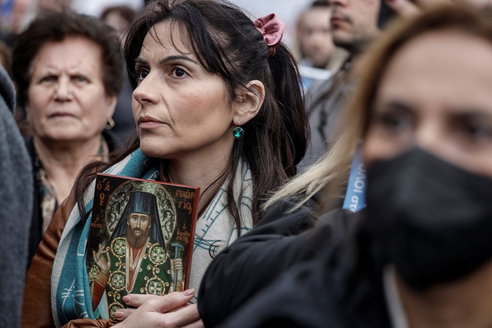 A woman holds a holy icon during a protest against a bill allowing LGBT+ marriage in the Greek capital Athens. Photo: Louisa Gouliamaki/Reuters