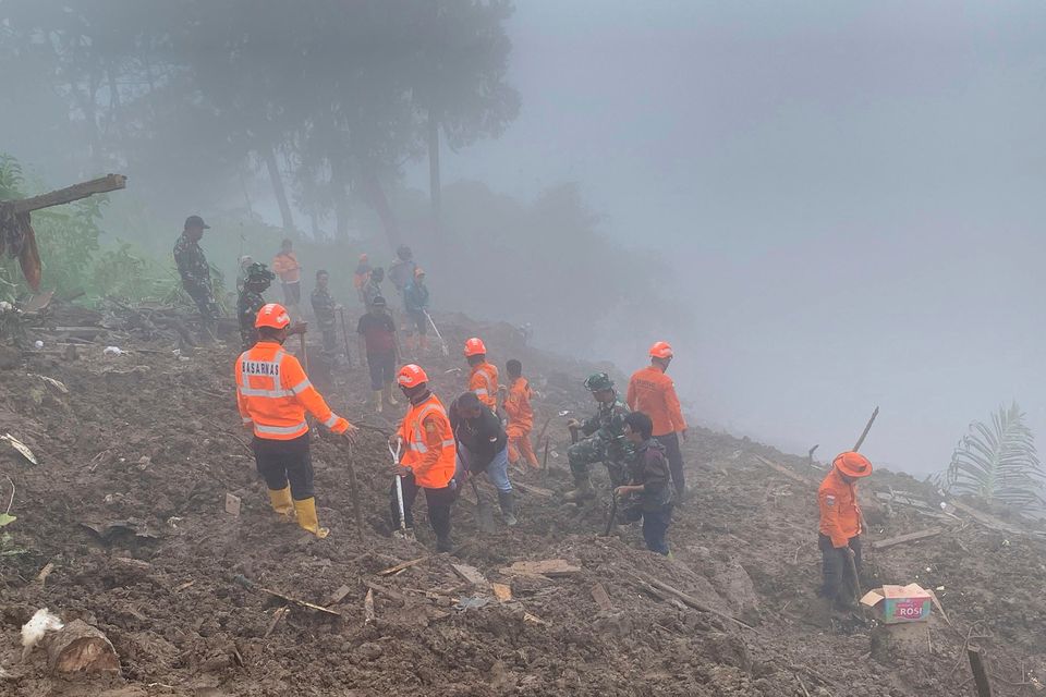 In this photo released by the Indonesian National Search and Rescue Agency (BASARNAS), rescuers search for survivors at a village hit by a landslide in Tana Toraja district of South Sulawesi province, Indonesia, Monday, April 15, 2024. A search and rescue team found multiple people killed by landslides on Indonesia's Sulawesi island and are still looking for a few missing, officials said Monday. (National Search and Rescue Agency via AP)