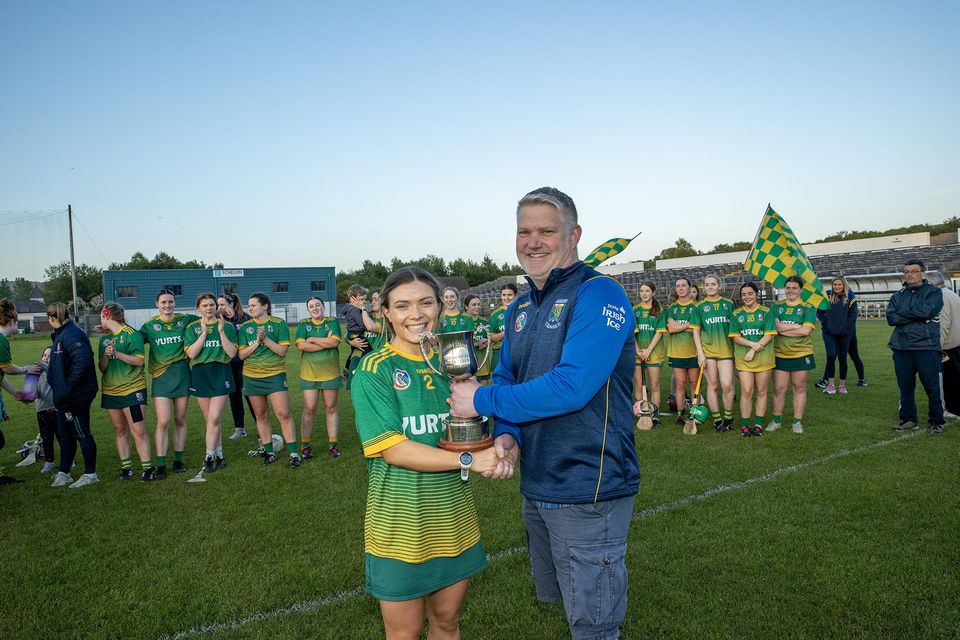 Emily Mulhall receives the league cup from Wicklow Camogie Chairman Ivor Lehane. 