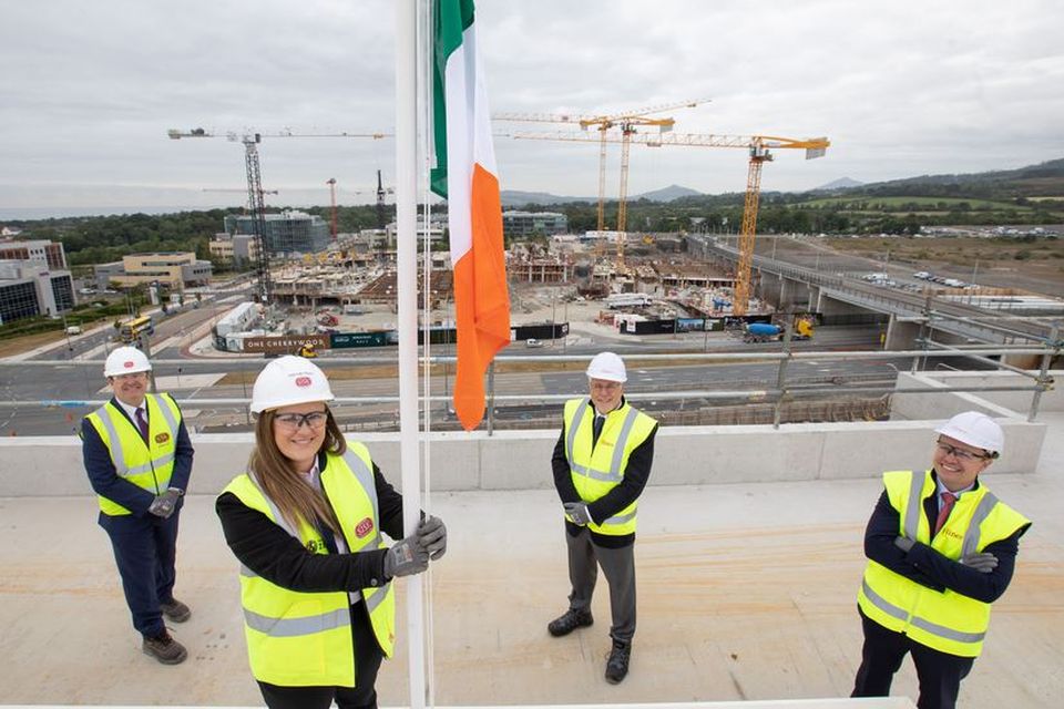Hannah Ward, a health and safety officer at Sisk in Cherrywood raising the Irish tricolour watched (L to R) by Donal McCarthy, COO (Ireland and Europe) John Sisk & Son, Brian Moran, Senior MD, Hines and Gary Corrigan, MD at Hines.