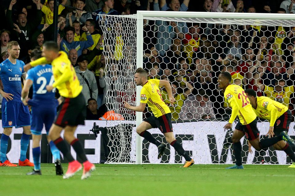 Tom Cleverley wheels away in celebration, pursued by his team-mates after another decisive late goal for Watford