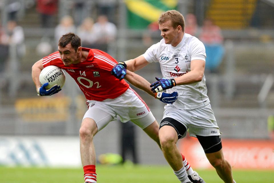 Donncha O'Connor, Cork, in action against Peter Kelly, Kildare.