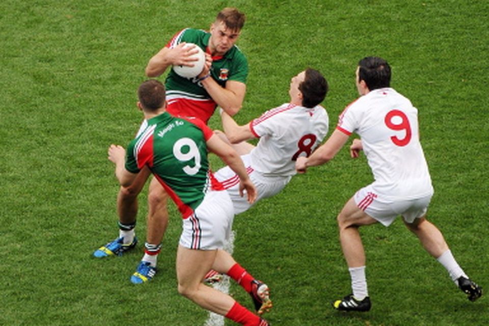 Mayo midfielders and brothers Aidan, top, and Seamus O'Shea, in action against brothers, Sean, right, and Colm Cavanagh