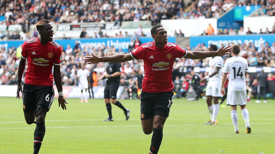 Anthony Martial (right) celebrates scoring his side's fourth goal with team-mate Paul Pogba at Swansea (Nick Potts/PA)