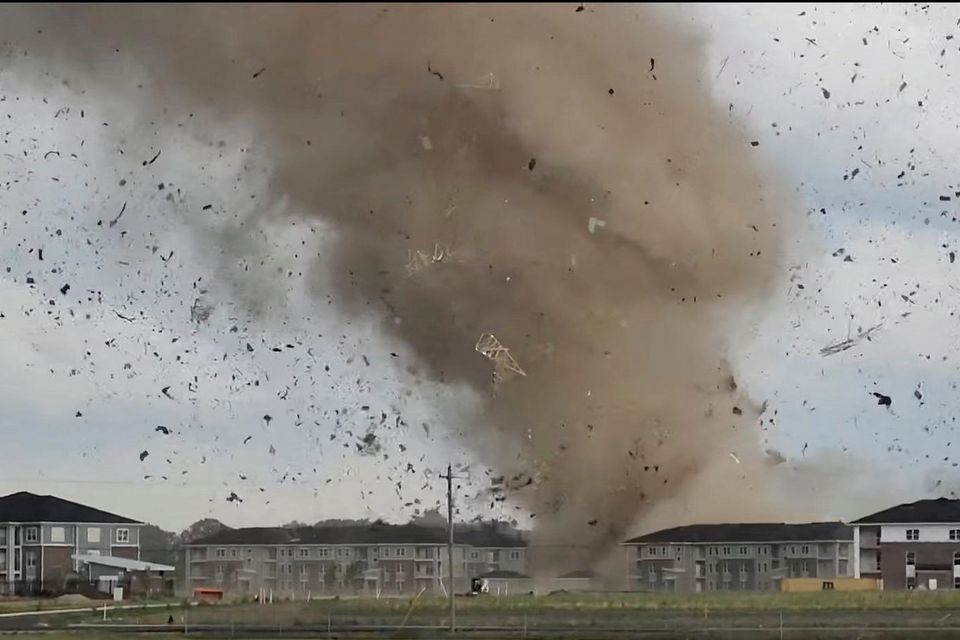 Debris is lifted into the air by a tornado during severe weather near Greenwood, Indiana. Photo: Reuters/Eric Ford via TMX.