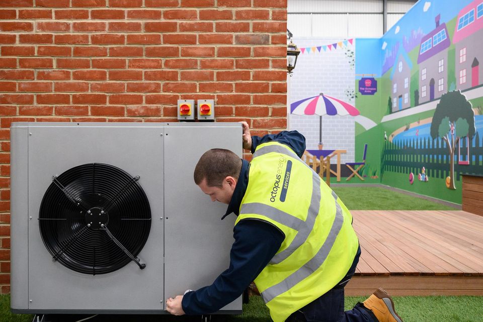 Installing a heat pump. Photo: Leon Neal/Getty Images