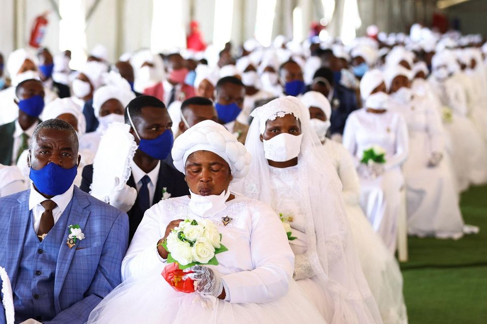 A bride and a groom wait during the mass wedding ceremony in Kgabalatsane, South Africa. Photo: Reuters/Siphiwe Sibeko