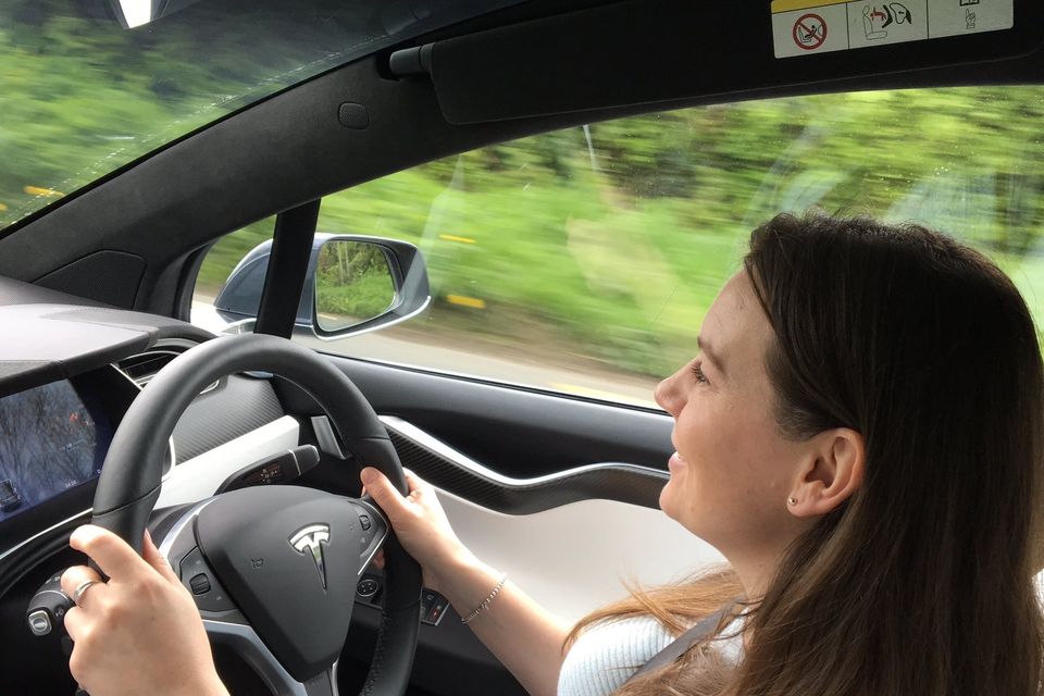 Melanie May behind the wheel of the Tesla Model X