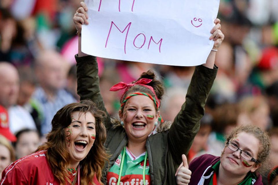 Mayo supporters Nuala Connolly, centre, from Kilmaine, and her friends Laura Muldoon, from Mulranny, and Hanna Callaghan, from Achil, send good wishes to their mother's in the Davin stand of Croke Park.