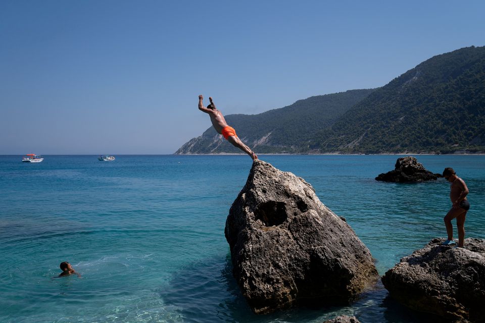 Wish you were here?: A holidaymaker takes a dip in the Greek island of Lefkada. Photo: Dimitris Rapakousis/ Reuters