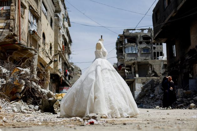 In war scarred Gaza, brides turn to refurbished wedding dresses in bid to keep fading tradition alive