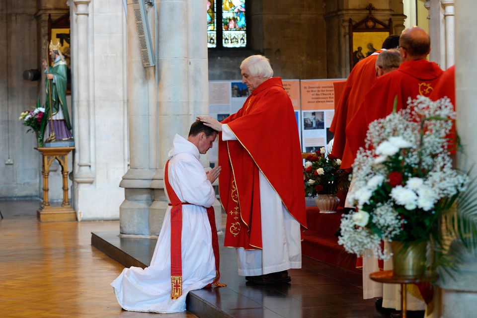 Priests line-up to touch the head of Father Philip Mulryne during his ordination ceremony.  Ordination of Reverend Brother Philip Mulryne. St. Saviour's Church, Dominick Street, Dublin. Picture: Caroline Quinn
