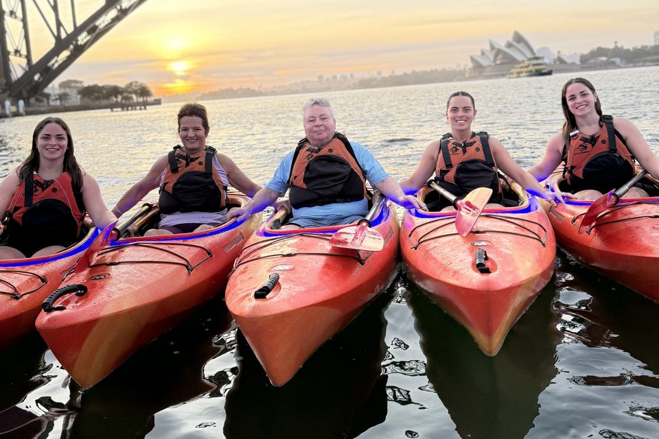 The Farrelly family on a sunrise kayaking trip in Sydney, Australia