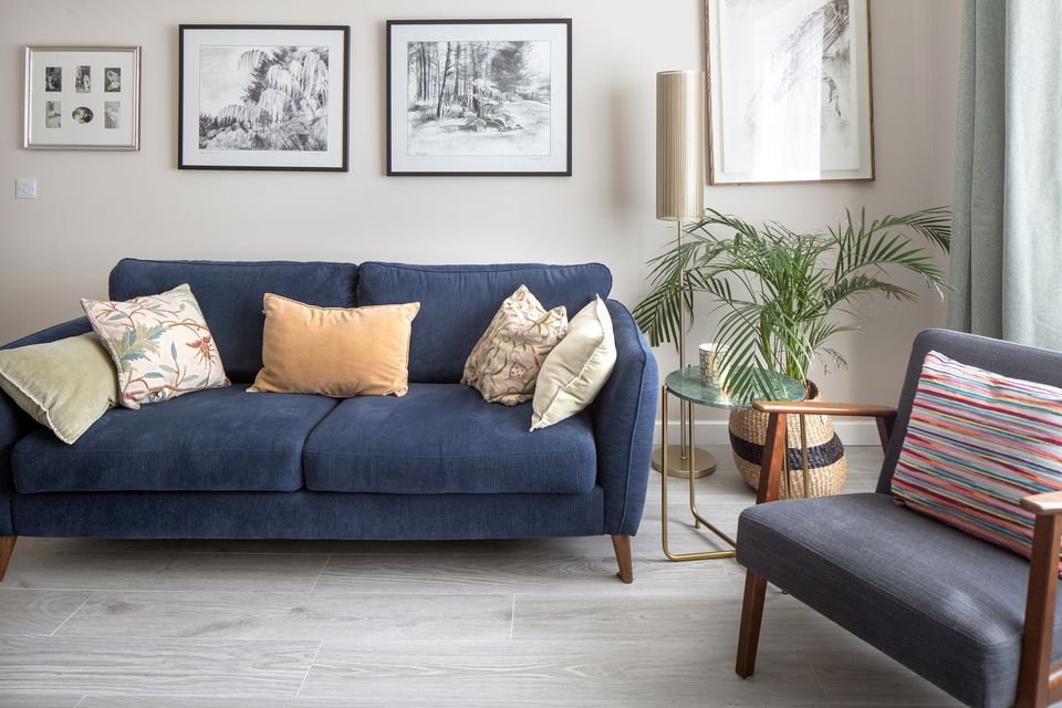 Melissa's living room. The sofa and armchair are from Flanagan Kearns, and the marble-topped table is from Ryle Designs. Above the sofa are prints of her works. Photo: Tony Gavin