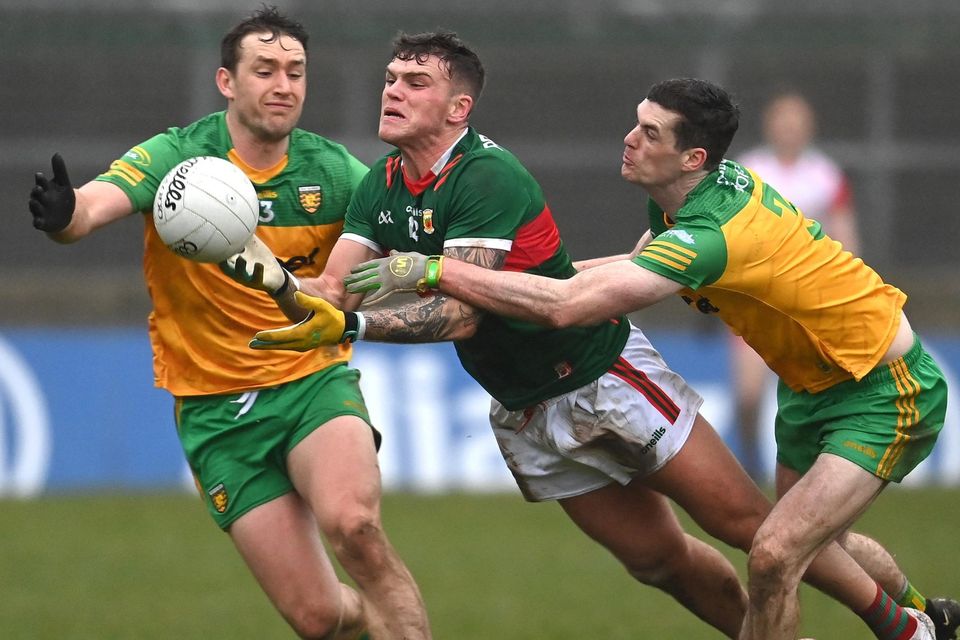 Jordan Flynn of Mayo in action against Hugh McFadden, left, and Caolan Ward of Donegal in a dour game in Ballybofey. Photo: Ramsey Cardy/Sportsfile