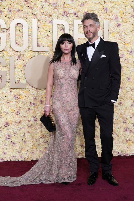 Christina Ricci, left, and Mark Hampton arrive at the 81st Golden Globe Awards on Sunday, Jan. 7, 2024, at the Beverly Hilton in Beverly Hills, Calif. (Photo by Jordan Strauss/Invision/AP)