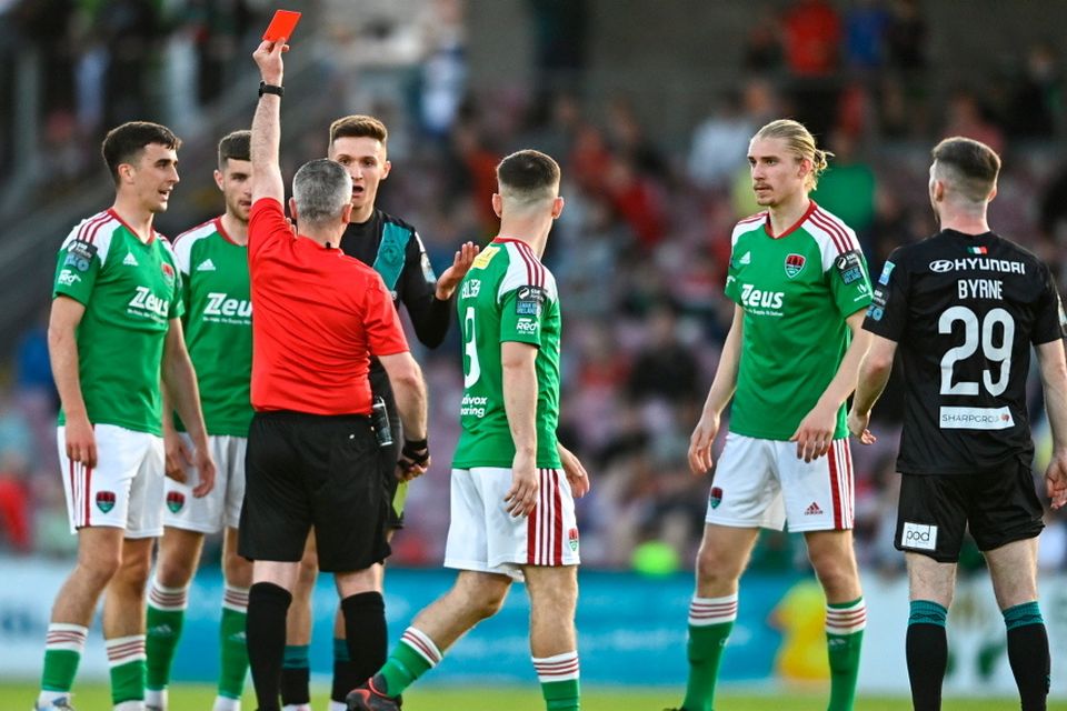 Johnny Kenny of Shamrock Rovers is shown a red card by referee Sean Grant