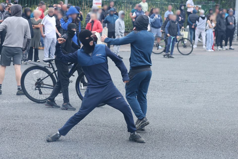 A protester throws a missile during rioting in Coolock. Photo: Collins