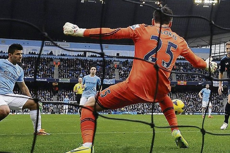 Manchester City's Sergio Aguero (L) shoots past Hugo Lloris. Photo: Nigel Roddis/ Reuters