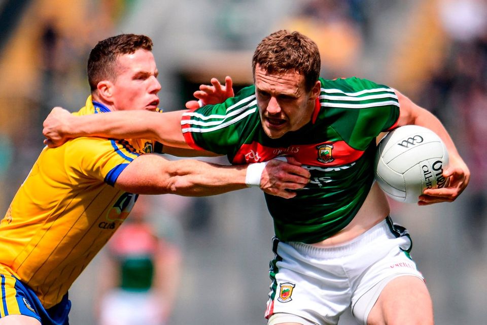 Andy Moran of Mayo is tackled by Sean McDermott of Roscommon during the GAA Football All-Ireland Senior Championship Quarter Final replay match between Mayo and Roscommon at Croke Park in Dublin. Photo by Ramsey Cardy/Sportsfile