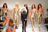 thumbnail: Top models (from left) Carla Bruni, Claudia Schiffer, Naomi Campbell, Cindy Crawford and  Helena Christensen walk the runway with Italian designer Donatella Versace (C) at the end of the show for fashion house Versace during the Women's Spring/Summer 2018 fashion shows in Milan, on September 22, 2017.  / AFP PHOTO / Miguel MEDINAMIGUEL MEDINA/AFP/Getty Images