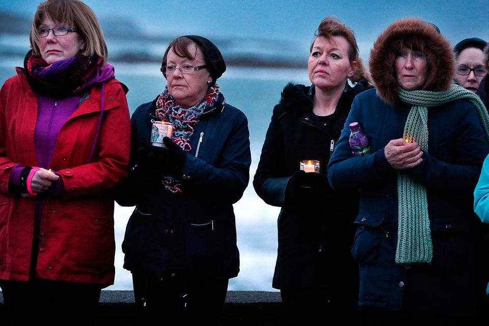 A evening prayer vigil held for the familes and crew of Rescue 116 with Blackrock Lighthouse in the distance near Blacksod Co Mayo. Credit: Steve Humphreys