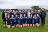 thumbnail: The Coláiste Ráithín team with coach Sarah Uí Dhuinn at the Wicklow Schools Junior 'A' Shield final.
