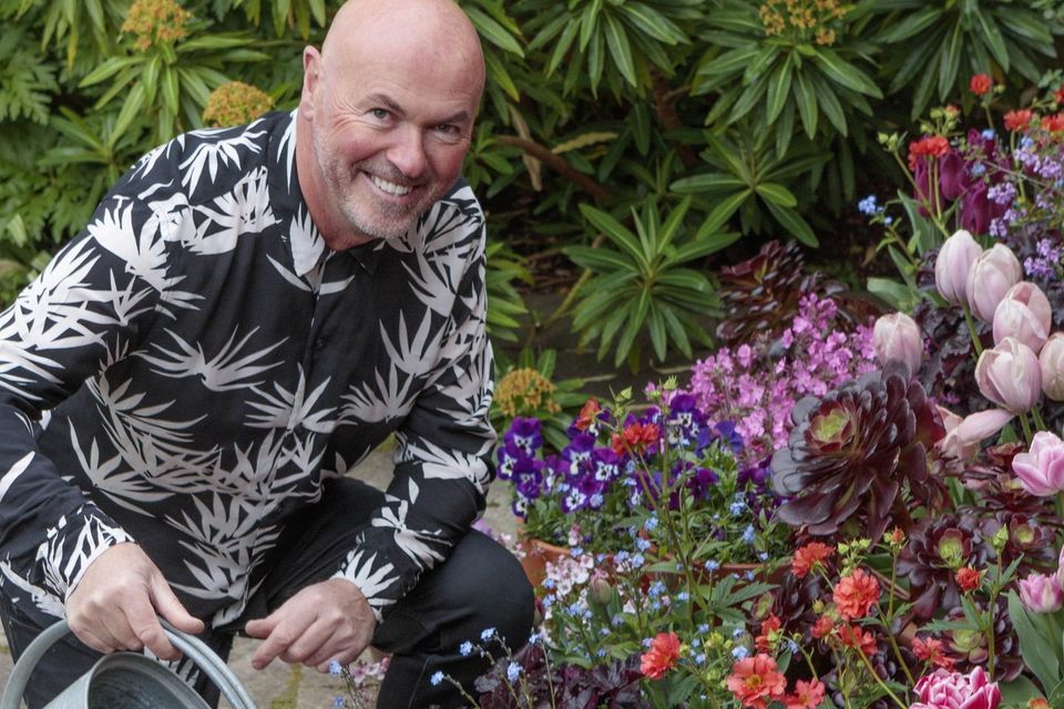 TJ Maher watering some of the pot displays at Patthana Garden.