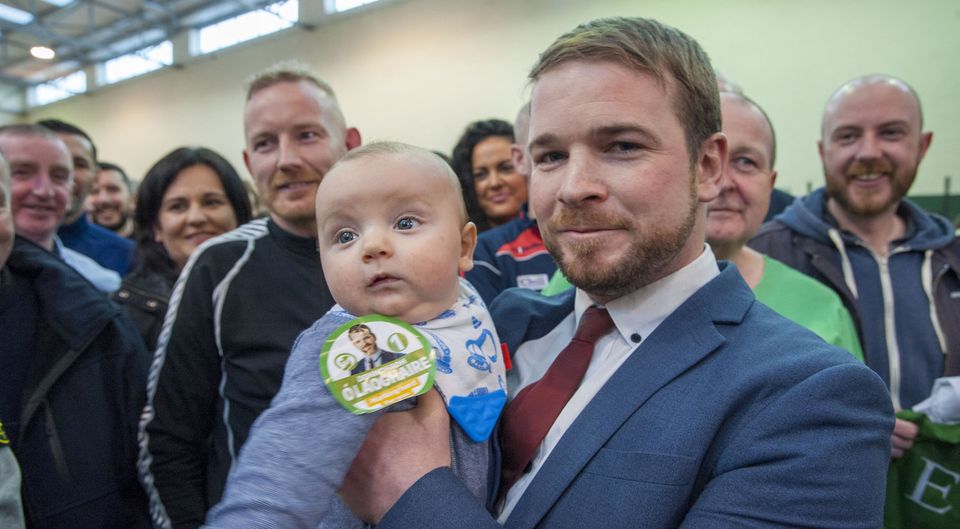 Young vote: Sinn Féin’s Donnchadh Ó Laoghaire celebrates with son Fiach (4 months) as he becomes the first TD to be elected to the 33rd Dáil. Photo: Daragh Mc Sweeney/Provision