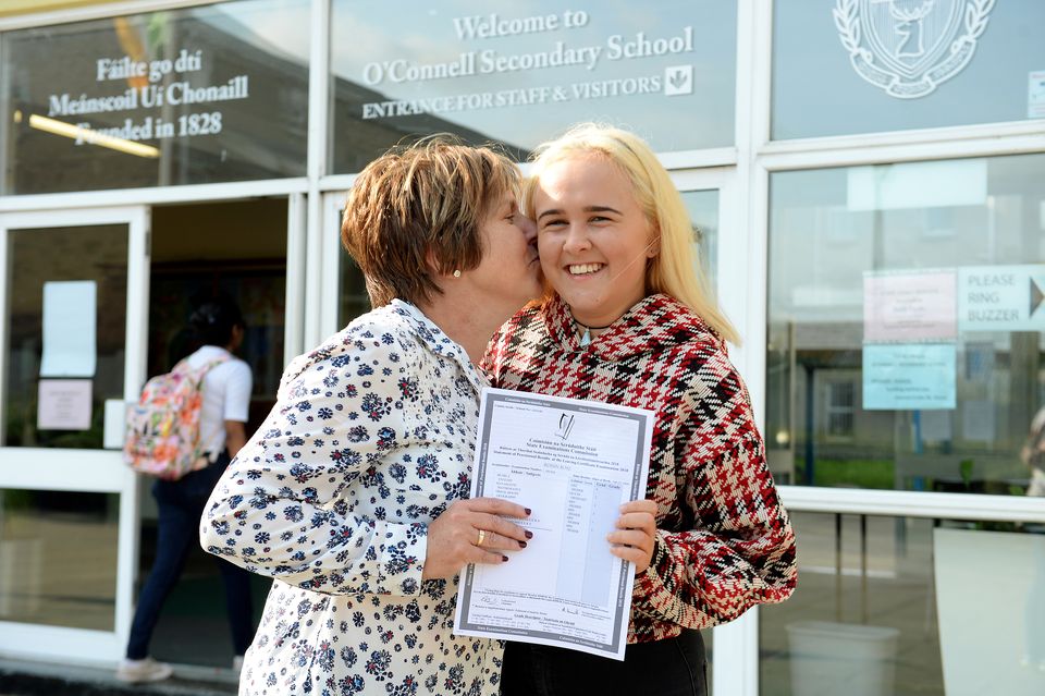 Roisin Rose gets a kiss from her mother Fiona, after she receives Leaving Cert Results 
Picture: Caroline Quinn