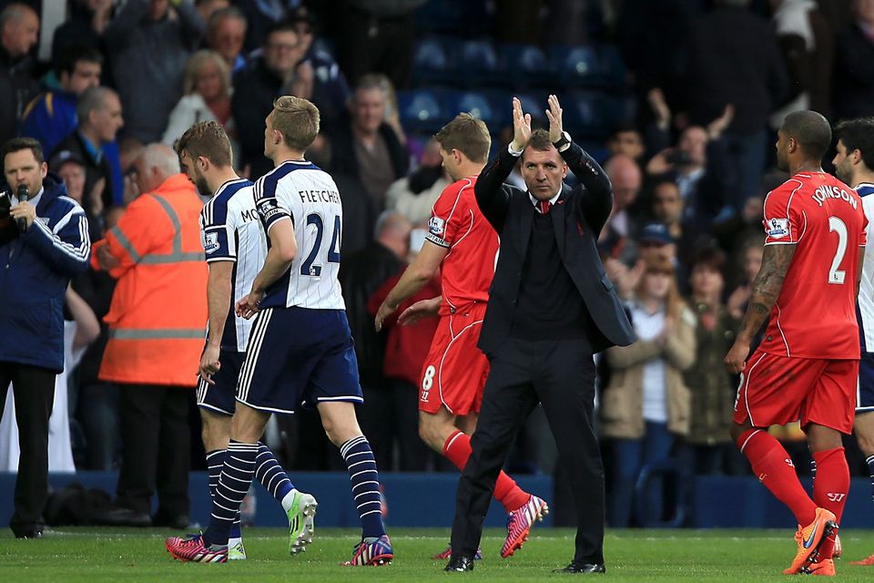 Liverpool manager Brendan Rodgers (centre right) applauds supporters after the final whistle during the Barclays Premier League match at The Hawthorns, West Bromwich.