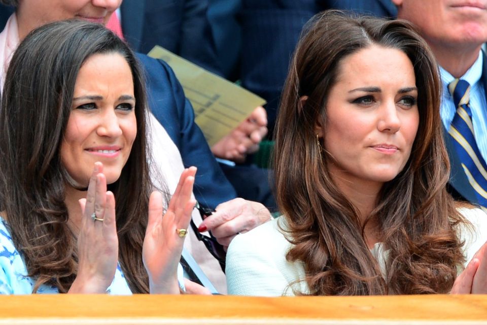 Catherine, Duchess of Cambridge and her sister Pippa Middleton (L) watch from the Royal Box before the men's singles final match between Britain's Andy Murray and Switzerland's Roger Federer on Centre Court on day 13 of the 2012 Wimbledon Championships