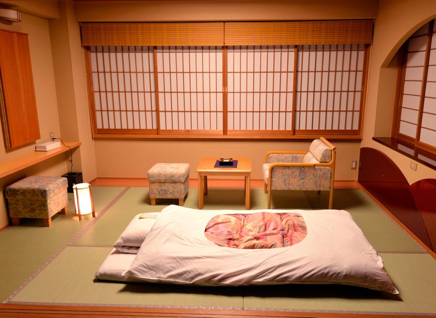 A futon is laid out for the evening at a ryokan, or traditional Japanese Inn. Omotenashi no Yado Keizankaku, outside Kyoto.