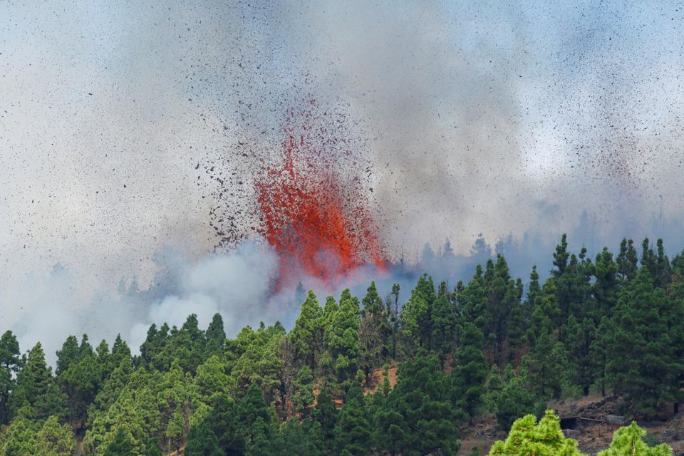 Lava and smoke are seen following the eruption of a volcano in the Cumbre Vieja national park at El Paso, on La Palma. Photo: Reuters/Borja Suarez