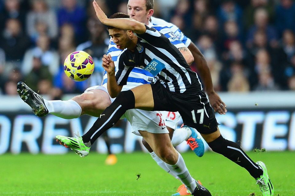 Ayoze Perez of Newcastle United and Richard Dunne of QPR battle for the ball. Photo credit: Mark Runnacles/Getty Images