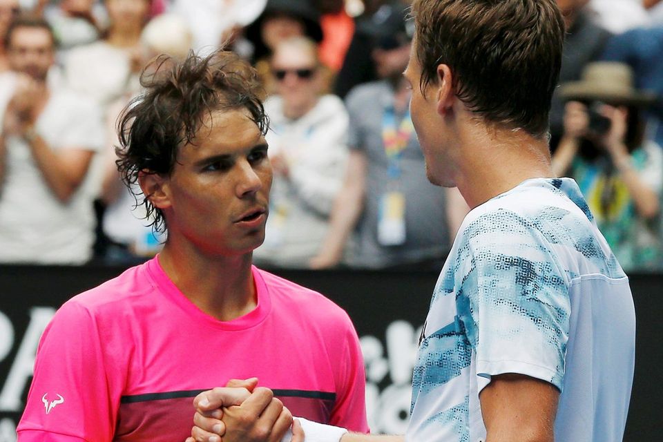 Tomas Berdych of the Czech Republic shakes hands with Rafael Nadal of Spain after defeating him in their men's singles quarter-final match at the Australian Open in Melbourne